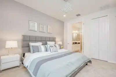 a large bedroom with a large bed and a lamp at Premium Comfort - Beautiful Home Private Pool in Kissimmee