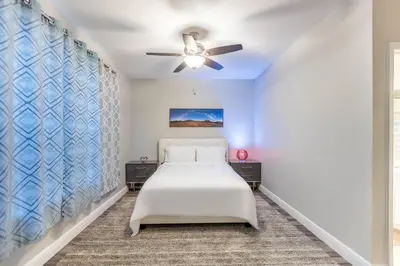 a bedroom with a bed and a ceiling fan at 3BR Townhouse w Perfect Location in Orlando