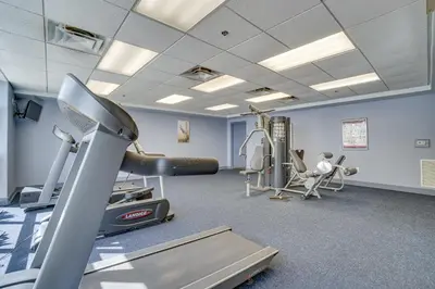 a fitness room with a treadmill and a gym at 1 Mi to Disney World Lakefront Condo in Orlando! in Orlando