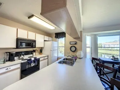 a kitchen with a counter top and a kitchen with a table at Lovely 3 bed Condo Near Disney Quiet Community condo in Kissimmee