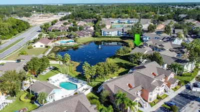 an aerial view of a neighborhood with houses and a lake at Lovely 3 bed Condo Near Disney Quiet Community condo in Kissimmee