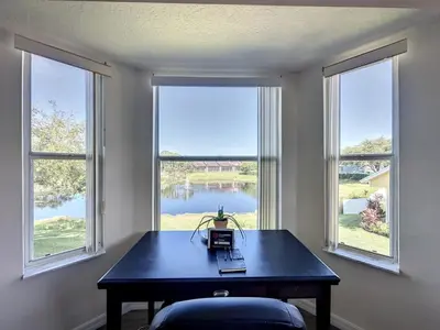 a room with a table and two large windows at Lovely 3 bed Condo Near Disney Quiet Community condo in Kissimmee