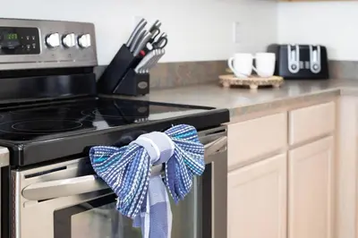 a kitchen with a stove with a blue and white towel at 545 -Beautiful 4 Bed Home with Sparkling Pool and Games Room in Orlando