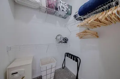 a laundry room with a sink and a shelf with towels at 545 -Beautiful 4 Bed Home with Sparkling Pool and Games Room in Orlando