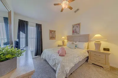 a bedroom with a large bed and a window at 545 -Beautiful 4 Bed Home with Sparkling Pool and Games Room in Orlando
