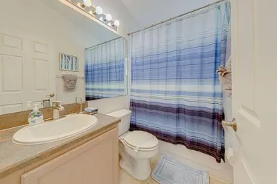 a bathroom with a sink and a toilet and a shower at 545 -Beautiful 4 Bed Home with Sparkling Pool and Games Room in Orlando