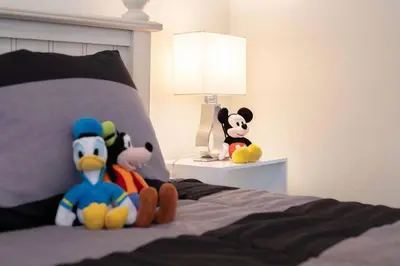 a group of stuffed animals sitting on a bed at 545 -Beautiful 4 Bed Home with Sparkling Pool and Games Room in Orlando