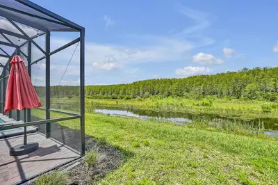 a view of a river from a house with a mirror at NEW Themed 10B VillaPoolSpa in Kissimmee