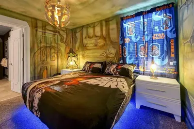 a bedroom with a large bed with a painting on the wall at NEW Themed 10B VillaPoolSpa in Kissimmee