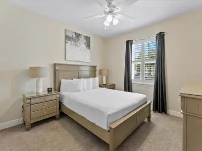 a bedroom with a large bed and a window at Family Friendly Home With Private Pool, Game Room, Waterpark & Resort Access Near Disney At Encore Resort - 7638Wi in Kissimmee