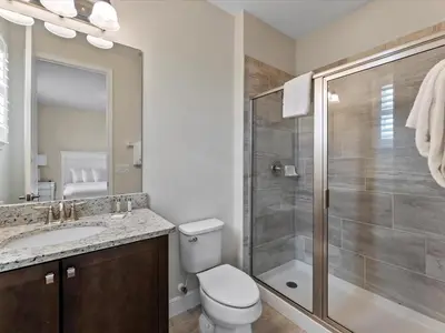 a bathroom with a toilet sink and a shower at Family Friendly Home With Private Pool, Game Room, Waterpark & Resort Access Near Disney At Encore Resort - 7638Wi in Kissimmee
