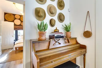 a room with a piano and hats on the wall at Fire Pit and Yard Updated Winter Garden Home! in Orlando
