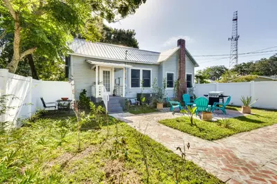 a small blue house with a white fence at Fire Pit and Yard Updated Winter Garden Home! in Orlando
