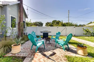 a patio with four green chairs and a table at Fire Pit and Yard Updated Winter Garden Home! in Orlando