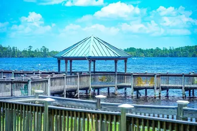 a wooden pier with a gazebo on the water at Aparment 2nd floor 5 minutes from Disney in Orlando