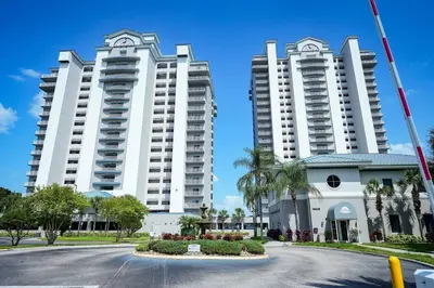 two large white apartment buildings with a street in front at Orlando Apt 9th Floor 5 min from Disney in Orlando