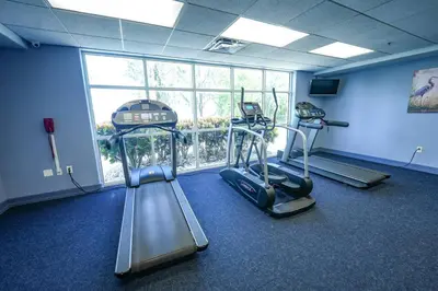 a gym with two treadmills and two exercise bikes at Orlando Apt 9th Floor 5 min from Disney in Orlando