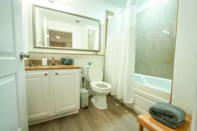 a bathroom with a toilet and a sink and a shower at Orlando Apt 10th floor 5 min from Disney in Orlando