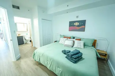 a bedroom with a large bed with blue walls at Apartment 5 min away from Disney 1st Floor in Orlando