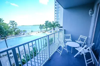 a balcony with a table and chairs and a pool at Apartment 5 min away from Disney 1st Floor in Orlando
