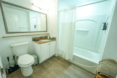 a bathroom with a white toilet and a shower at Apt Orlando 11th floor 5 minutes from Disney in Orlando