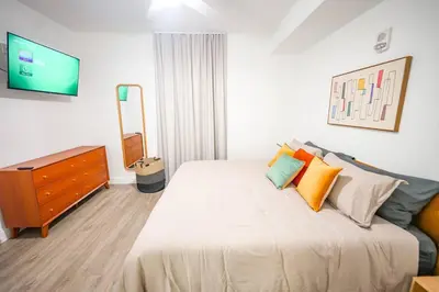 a bedroom with a bed and a dresser and a television at Apt Orlando 11th floor 5 minutes from Disney in Orlando