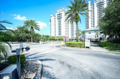 an empty street with palm trees and tall buildings at Orlando Blue Heron condo 1 mile from Disney in Orlando