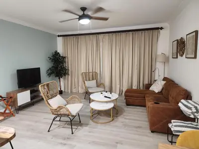 a living room with a couch and a table and chairs at Orlando Blue Heron condo 1 mile from Disney in Orlando