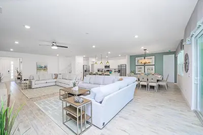 a living room with a white couch and a table at 15BR Mansion Near Disney Private Pool Hot Tub in Kissimmee