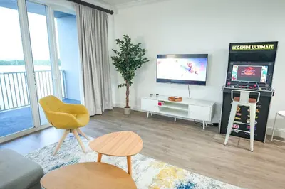 a living room with a television and a living room with at Renovated Condo Blue Heron 5 pax in Orlando