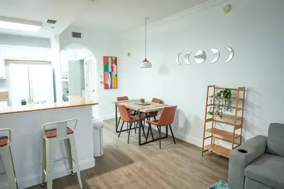 a kitchen and living room with a table and chairs at Renovated Condo Blue Heron 5 pax in Orlando