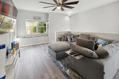 a living room with a couch and a ceiling fan at Amazing Disney Themed Oasis 3BR near Parks townhouse in Orlando