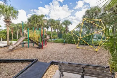 a playground with a slide and a bench at Amazing Disney Themed Oasis 3BR near Parks townhouse in Orlando
