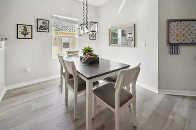 a dining room with a table and chairs at Amazing Disney Themed Oasis 3BR near Parks townhouse in Orlando