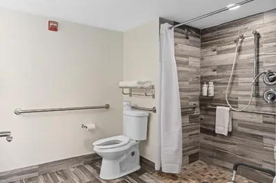 a bathroom with a toilet and a shower at Baymont by Wyndham Orlando Downtown in Orlando