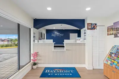 a shop with a blue sign on the wall at Baymont by Wyndham Orlando Downtown in Orlando