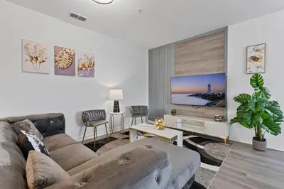 a living room with a couch and a flat screen tv at Amazing Apartment 3Brdm - 5 miles from Disney in Kissimmee