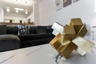 a gold object on a table in a living room at Amazing Apartment 3Brdm - 5 miles from Disney in Kissimmee