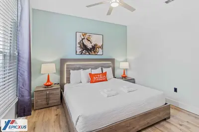 a bedroom with a large bed and two lamps at The Epic Madrid Vista Cay Orlando in Orlando