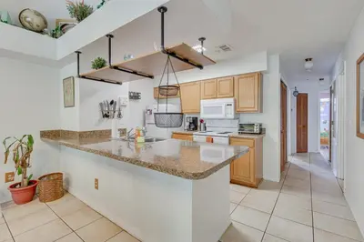 a kitchen with a large island in the middle at 6 Mi to Disney Family-Friendly Condo in Kissimmee in Kissimmee