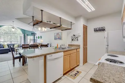 a kitchen with a sink and a counter top at 6 Mi to Disney Family-Friendly Condo in Kissimmee in Kissimmee