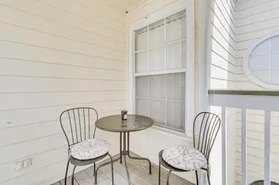 a table and two chairs on a porch with a window at 6 Mi to Disney Family-Friendly Condo in Kissimmee in Kissimmee