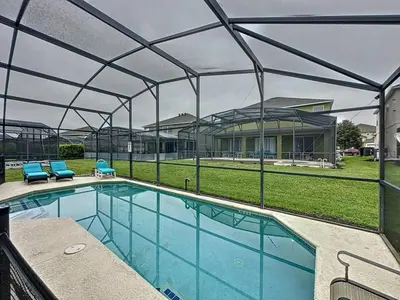 a swimming pool with a canopy over it at 4 BED 3 BATH IN A GATED COMMUNITY WITH POOL villa in Kissimmee