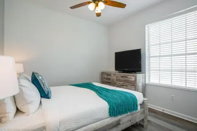 a bedroom with a bed and a flat screen tv at Luxury Remodeled! WOW! in Orlando