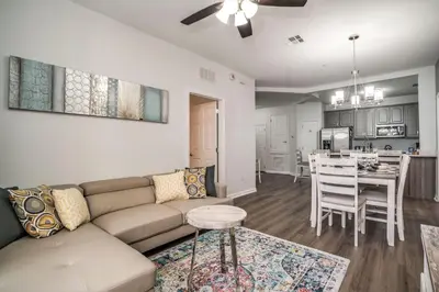 a living room and kitchen with a couch and a table at Luxury Remodeled! WOW! in Orlando
