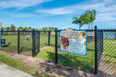 a chain link fence with a sign on it at 2971 Castaway Lane in Orlando