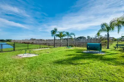 a park with a bench and palm trees at 2971 Castaway Lane in Orlando