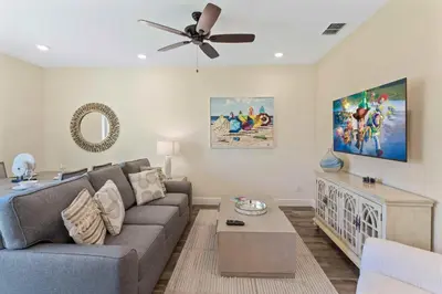 a living room with a couch and a ceiling fan at 2971 Castaway Lane in Orlando