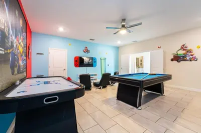 a room with a pool table and a tv at Magical 9BR Villa by Disney w Pool Theme Room in Kissimmee