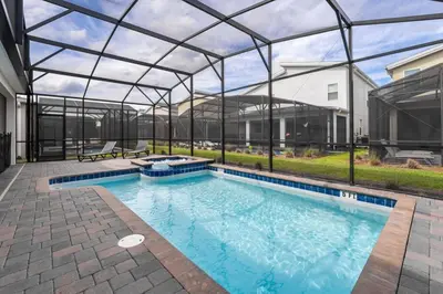 an indoor swimming pool with a glass roof at Magical 9BR Villa by Disney w Pool Theme Room in Kissimmee